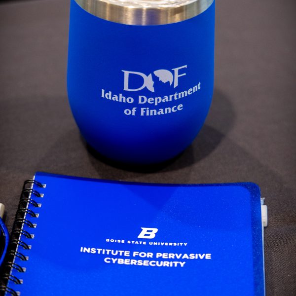 IDOF blue tumbler on table and BSU notebook on table