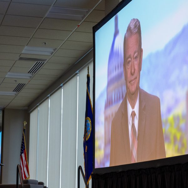 Governor Brad Little speaking on screen in a video.